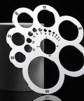 Metal circle template with multiple hole sizes from 5 to 60 on display, part of the Leather Corner Punch Set And Circle Template Tool For Leather Crafting Portable Round Corner Ruler Cutting Guide For Drafting DIY Projects Lightweight Compact Metal Template Kit.
