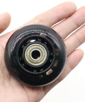 Close-up of 2.5 Inch Inline Skate Wheel 64mm with ABEC7 bearing, 82A hardness, black, held in hand, smooth glide, durable polyurethane