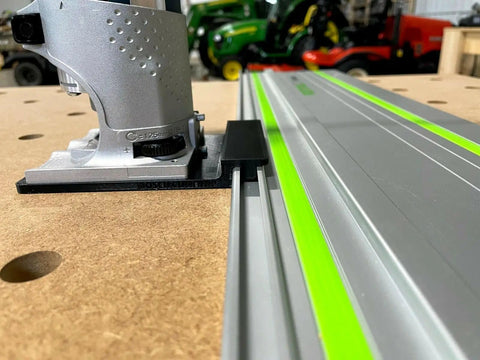 Guide Rail Adapter Compatible With Bosch Colt 1Hp Router For Track Saw Systems mounted on a guide rail with a hardwood base.
