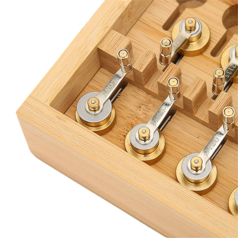 Close-up of Pro Grade Mainspring Winder Tool Kit With Copper Construction in a wooden storage box, showing precision winders.