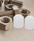 150 Pcs Plastic Dowel Inserts for Cabinet Doors, white hinge dowels beside metal bolts on textured surface