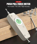 200 N Handheld Push Pull Force Gauge With Dual N Kgf Analog Dial And Peak Hold, Mounting Test Stand Ready, Perfect For Tensile And Compression Testing, Includes Multiple Attachment Heads And Extension Rod. White handheld gauge with dial and attachments on wood