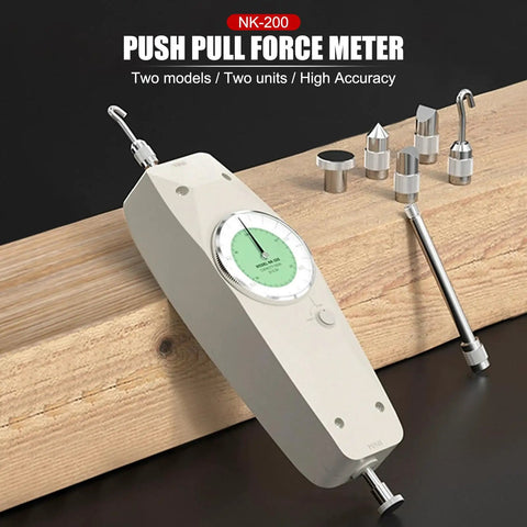 200 N Handheld Push Pull Force Gauge With Dual N Kgf Analog Dial And Peak Hold, Mounting Test Stand Ready, Perfect For Tensile And Compression Testing, Includes Multiple Attachment Heads And Extension Rod. White handheld gauge with dial and attachments on wood