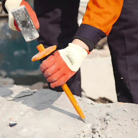 Worker using Beefy 12-Inch Flat Chisel With Bi-Material Hand Guard for demolishing concrete, wearing gloves, heat treated CRV steel.
