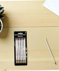 Six Piece White Sketch Pencils Set For Charcoal Drawing Artists And Newbies Soft Medium Hard Graphite in packaging on desk