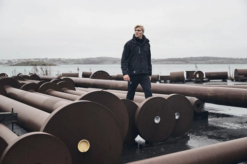 Man wearing Men's Waterproof Shell Jacket With Detachable Hood And High Collar, Breathable Fully Taped Seams, Black Large, outdoors