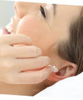 Person inserting Snag These 40 Count Reusable Silicone Ear Plugs Soft Tight Seal Keeps Ears Dry Swimming Or Showering Noise Blocking Cushion.