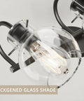 Close-up of Black Vanity Light 3 Light Modern Bathroom Fixtures Over Mirror With Globe Glass Shade Matte Black Finish E26 Base