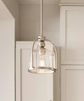 One Light Mini Pendant In Brushed Nickel, Cool Modern Steel Fixture for Kitchen Islands, shown with glass shade in kitchen setting