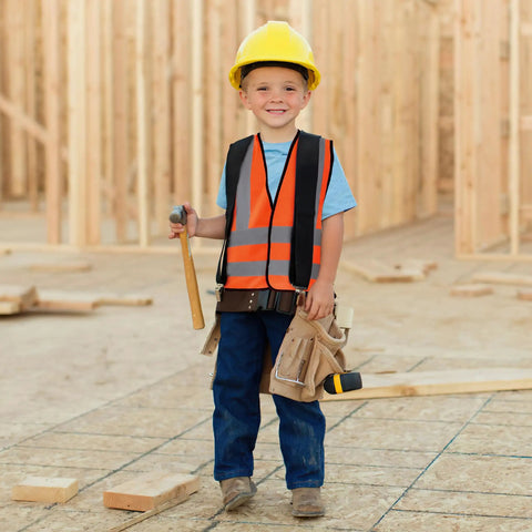Premium Bright Orange Custom Printed Kids Reflective Vest High Visibility Safety Gear For School Run With Slick Adjustable Straps That Make Your Custom Print Look Absolutely Dope worn by child on construction site, smiling, holding a hammer.