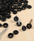 150 Pack Black Plastic Screw Caps For Covering Screw Heads Fits Size 6 And Size 8 Screws M3 M4 on wooden surface