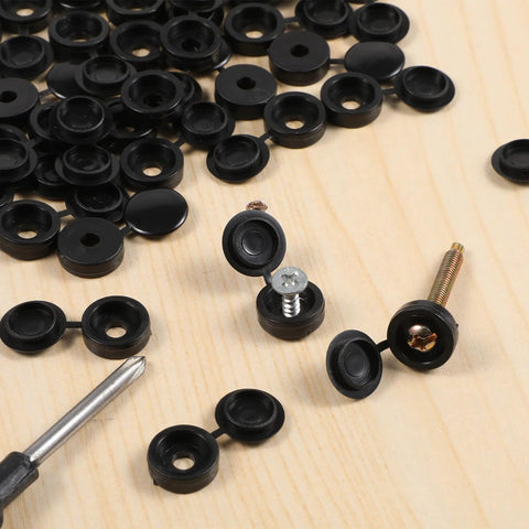 150 Pack Black Plastic Screw Caps For Covering Screw Heads Fits Size 6 And Size 8 Screws M3 M4 on wooden surface