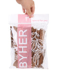 Straight Up Essential 4 Inch Craft Sticks, 45 Pcs Natural Wood Twigs With Original Bark in clear packaging, hand holding.