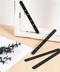 Stainless Steel Straight Brace Plates For Wood 4 Pack Black Flat Mending Brackets shown on a desk near a white window frame