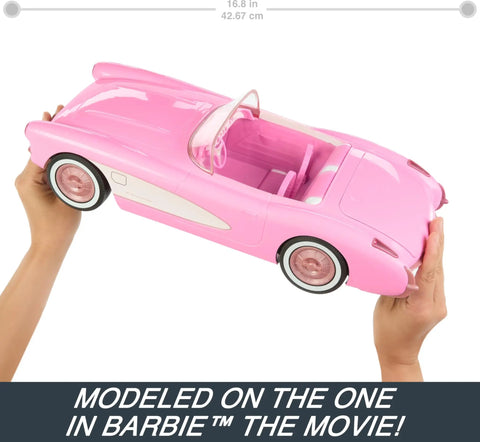 Remote Control Corvette Toy Car From Barbie Movie held by hands showing pink car with open seats, trunk closed