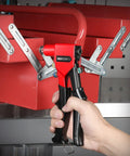 Pro Grade Hand Riveter Kit With Four Interchangeable Heads for metal work, tool held over red metal piece for installation