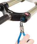 Hand using Pro Grade Snap Ring Pliers Set RPSET-2 With Straight Internal Tip to maintain bike suspension