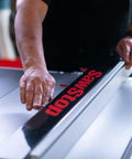 Close-up of hand adjusting Advanced T Glide Rip Fence Rock Solid Design With Dovetail Slots Compatible With Industrial Cabinet Saw.