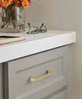 Mulholland Champagne Bronze Cabinet Pull 5-1/16 Inch Center to Center Drawer Handle installed on a grey cabinet