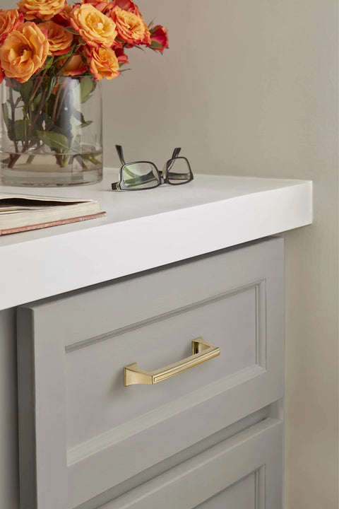 Mulholland Champagne Bronze Cabinet Pull 5-1/16 Inch Center to Center Drawer Handle installed on a grey cabinet
