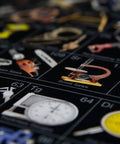 Close-up of Periodic Table Of Tools Poster showing various hand tools, including calipers and saws, on dark glossy paper.