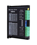Angled front view of DM542 microstep driver module with green terminal blocks on a black enclosure.