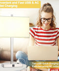 Woman using laptop beside 21 inch touch bedside lamp set of 2 with USB and AC outlets, 3 way dimmable in white shade