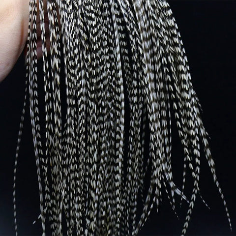 Close-up of 10-piece black and white dry fly tying feather set with presized saddle hackles 6-9 inches long sizes 12 through 14