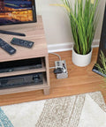 Beefy Four-Outlet Heavy Duty Power Strip With 3330 Joules Surge Protector under TV stand in living room setup