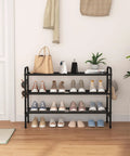 3 Tier Metal Shoe Rack Organizer 33 Inch Wide Built To Last Space Saving Shoe Storage With Four Side Hooks holding shoes in living room