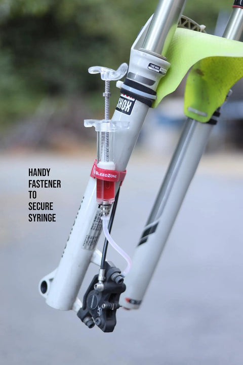 Shimano Hydraulic Brake Bleed Kit with 120ml mineral oil and Pro Syringe attached to mountain bike fork for maintenance