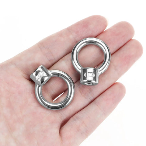Heavy Duty 316 Stainless Steel Lifting Eye Nuts In One Quarter Inch Unc Thread shown in hand for industrial rigging tasks.