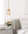 Gold Pendant Light Fixture For Kitchen Island And Dining Room with brass and bubble seeded glass over bedside table.