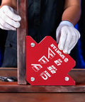 Hands positioning a Six Pack Heavy Duty Welding Magnet 25 Lb Each With Magnetic Angle Clamps For Hands Free Welding, bright red.