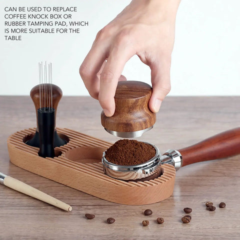 Top Shelf Espresso Tamper And Coffee Distributor Station Kit Featuring Natural Wood Handle Anti Slip Base Pro Level 53Mm Portafilter Tool For Home Kitchens with hand pressing coffee grounds.