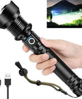 Person holding the Beast Mode 90,000 Lumen Rechargeable LED Flashlight With Zoomable Beam And 10 Modes, showing USB cable and night use.