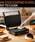 A person cleaning non-stick plates of a Stainless Steel 1000W Panini Press Grill And Sandwich Maker With Non Stick Plates Removable Drip Tray.