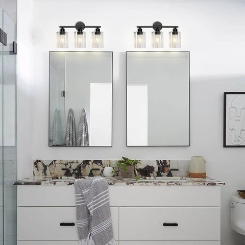 Modern bathroom with double mirrors, decorative lighting, and a stylish countertop arrangement.