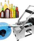 Ace Semi Automatic Round Bottle Labeler with labels on Metal frame, designed for bottles with 0.47 to 5.9 inch diameter.