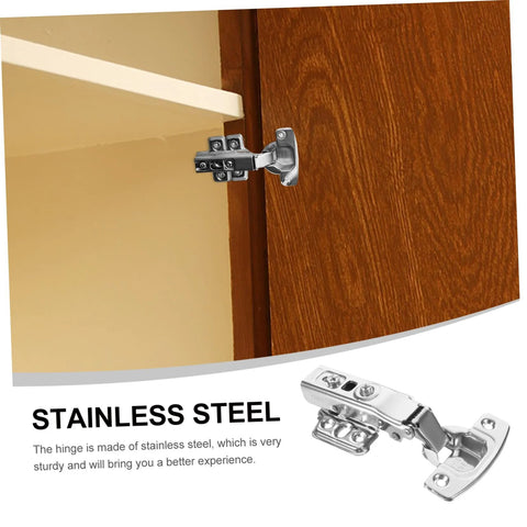 Set of 12 stainless steel cabinet hinges with mounting plates installed on a wooden kitchen cabinet door.