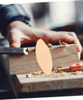 Close-up of a 100Pcs Wood Joining Biscuits Set For Rock Solid Furniture Joints, showing a light yellow biscuit and woodworking process.