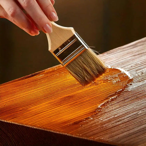 Top Shelf 100 Percent Pure Linseed Oil Wood Finish And Protective Sealer For Indoor Outdoor Furniture Plus Hardwood Surfaces Deeply Absorbs To Beat Sun And Rain Wear Keeping Grains Smooth And Radiant 32 Ounce Can being applied with a brush on wood.