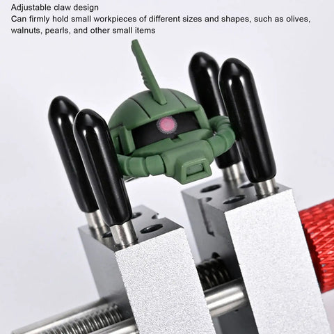 Mini Bench Vise Clamp For Jewelry Repair And Model Making Pro Grade Adjustable Parallel Jaws For Gripping Small Parts Up To 1.18 Inches Metal Silver With Protective Sleeves And 10 Holes, holding a small green model part