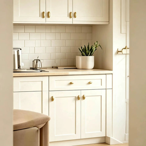 Top Shelf Brushed Brass Oval Cabinet Knobs And Zinc Alloy Single Hole Drawer Pulls Featuring Warm Olive Tones Four Pack on white kitchen cabinets.
