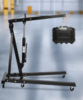 Smooth Operator Heavy Duty Hydraulic Engine Hoist Crane 2 Ton Shop Lift Rig with a weight, showing its sturdy design and wheels.