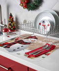 Holiday Themed Snowman Wood Grain Dish Drying Mat on kitchen counter under dish rack, 16x18 inches, cardinal decor visible