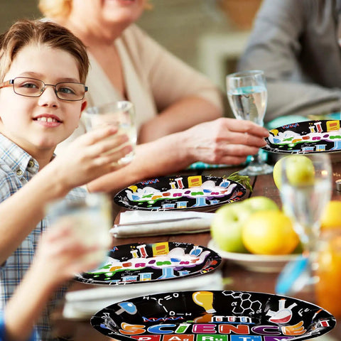 Kids using 96 Piece Science Party Tableware Set with 24 9 Inch Plates 24 7 Inch Plates 24 Napkins and 24 Forks in a party setting