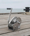 Tough As Nails 304 Stainless Steel Manual Winch Hoist Crank on dock, showcasing heavy duty gears for marine use.