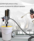 No Frills Heavy Duty Pneumatic Grease Pump For 5 Gallon Drums with a hose and nozzle in a workshop setting.