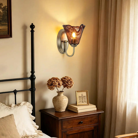 Vintage Glass Wall Sconces Set of 2,Aged Brass Bathroom Vanity Lighting with amber glass shade beside a bedside table.